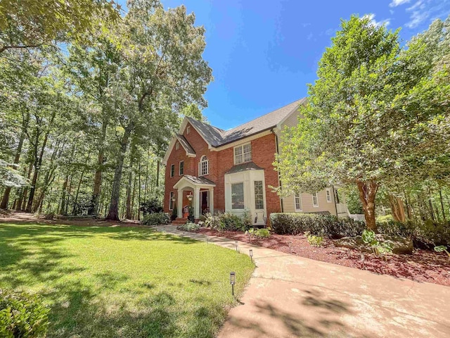 1020 Tallesse Trl, Greensboro, GA 30642 - colonial-style house featuring a front lawn and brick siding