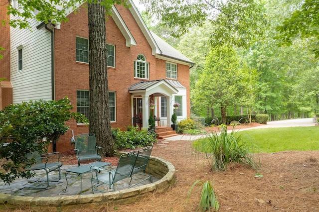 1020 Tallesse Trl, Greensboro, GA 30642 - view of front of home with brick siding, a standing seam roof, and a patio