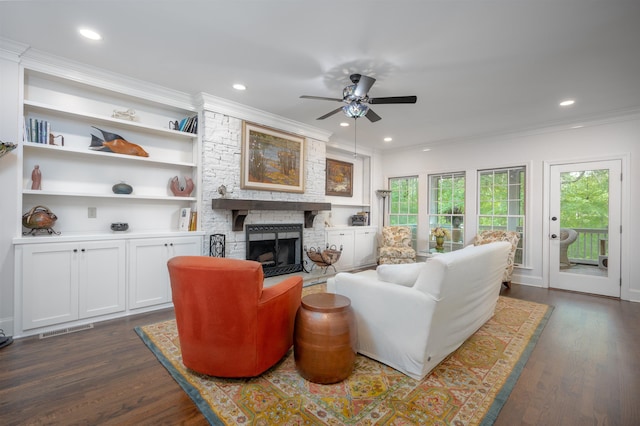 1020 Tallesse Trl, Greensboro, GA 30642 - living area with a ceiling fan, dark wood-type flooring, crown molding, recessed lighting, and a stone fireplace