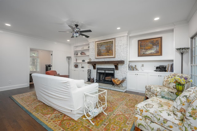 1020 Tallesse Trl, Greensboro, GA 30642 - living room with a stone fireplace, dark wood-style flooring, a ceiling fan, crown molding, and recessed lighting