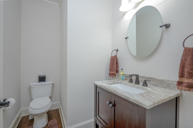 1020 Tallesse Trl, Greensboro, GA 30642 - half bathroom with vanity, toilet, wood finished floors, and baseboards