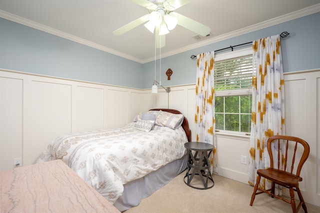 1020 Tallesse Trl, Greensboro, GA 30642 - carpeted bedroom featuring a decorative wall, crown molding, wainscoting, and a ceiling fan