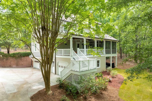 1020 Tallesse Trl, Greensboro, GA 30642 - view of front of home featuring stairs, a garage, driveway, covered porch, and a sunroom