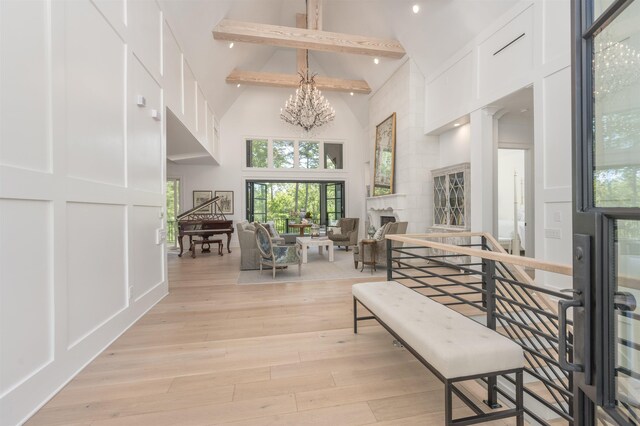 1100 Neary Rdg, Greensboro, GA 30642 - interior space featuring high vaulted ceiling, a decorative wall, light wood-type flooring, an inviting chandelier, and beam ceiling
