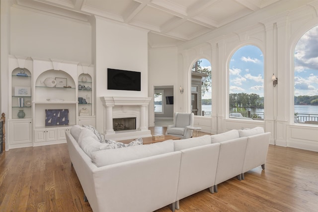 1191 Cory Cir, Greensboro, GA 30642 - living room with a fireplace with raised hearth, wood finished floors, beam ceiling, coffered ceiling, and ornamental molding