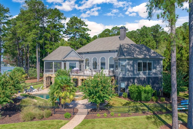 1191 Cory Cir, Greensboro, GA 30642 - rear view of property featuring a fenced backyard, a sunroom, a patio area, and a chimney