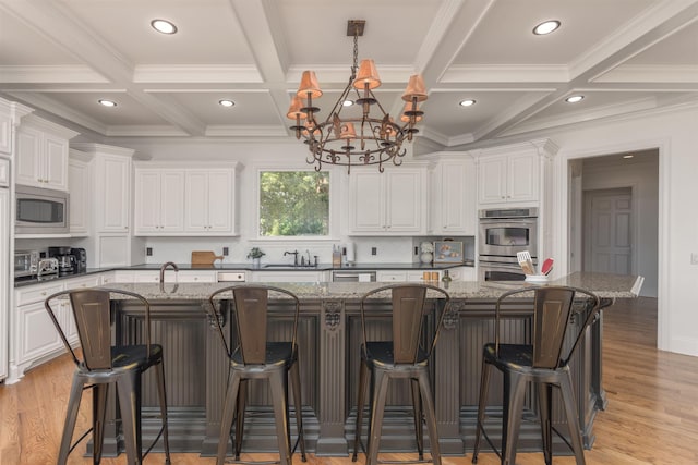 1191 Cory Cir, Greensboro, GA 30642 - kitchen with stainless steel appliances, coffered ceiling, a spacious island, white cabinets, and beamed ceiling