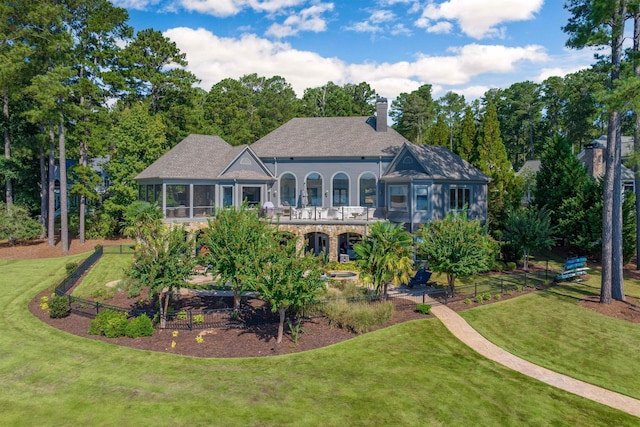 1191 Cory Cir, Greensboro, GA 30642 - rear view of property with a sunroom, a yard, a chimney, and view of scattered trees