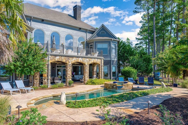 1191 Cory Cir, Greensboro, GA 30642 - back of property with a balcony, a patio, a chimney, and a pool with connected hot tub