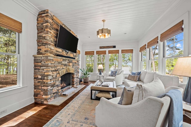 1081 Terrell Cir, Greensboro, GA 30642 - sunroom / solarium featuring plenty of natural light, wood-type flooring, a chandelier, and crown molding