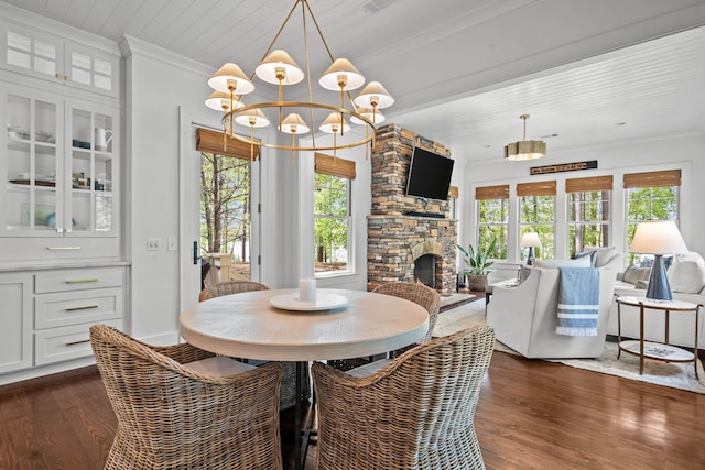 1081 Terrell Cir, Greensboro, GA 30642 - dining room with a chandelier, dark wood-style flooring, crown molding, and a fireplace