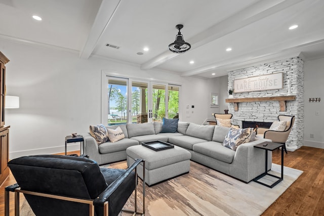 1081 Terrell Cir, Greensboro, GA 30642 - living area with beamed ceiling, a stone fireplace, wood finished floors, and recessed lighting