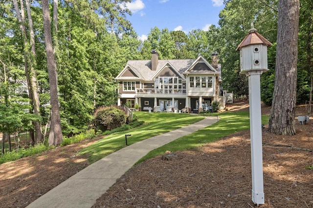 1081 Terrell Cir, Greensboro, GA 30642 - view of front of house featuring a front yard, a chimney, a wooden deck, and roof with shingles