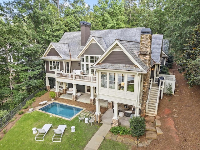 1081 Terrell Cir, Greensboro, GA 30642 - rear view of house featuring a chimney, stairway, a patio, and a fenced backyard