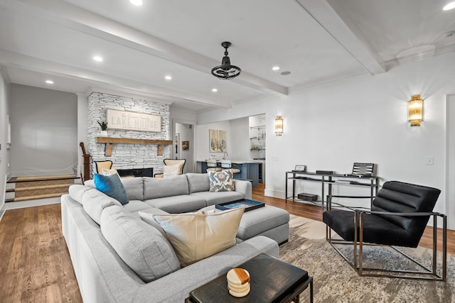 1081 Terrell Cir, Greensboro, GA 30642 - living area featuring wood finished floors, beam ceiling, a fireplace, recessed lighting, and stairs