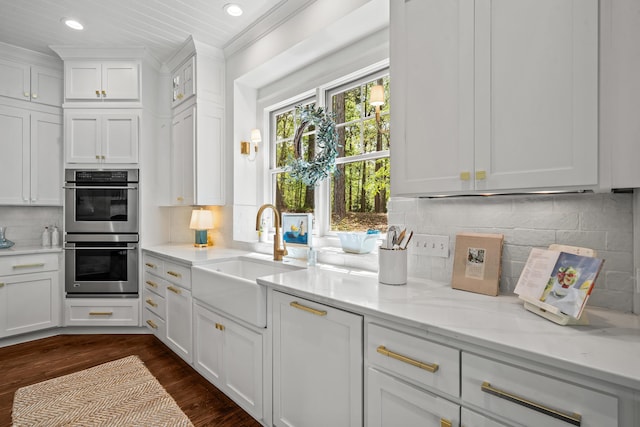 1081 Terrell Cir, Greensboro, GA 30642 - kitchen with double oven, recessed lighting, crown molding, white cabinets, and decorative backsplash