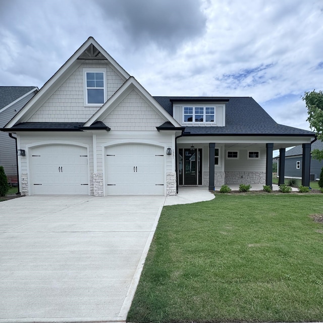 view of front of home with a garage and a front yard