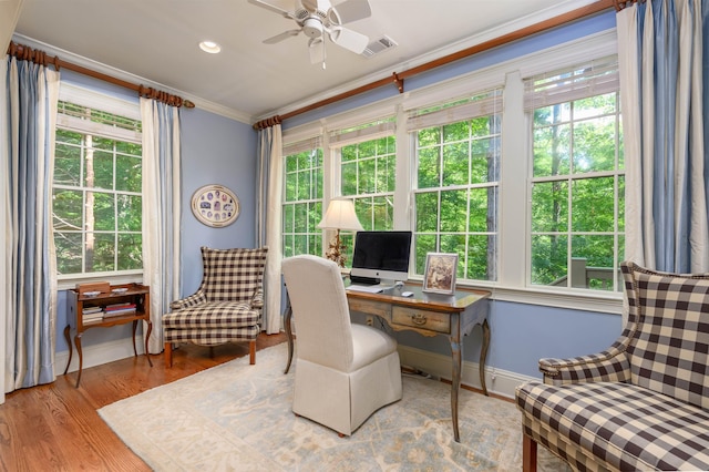 home office featuring crown molding, ceiling fan, and light hardwood / wood-style floors