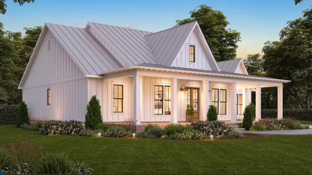 1010 Troon Ct, Greensboro, GA 30642 - modern farmhouse style home featuring a porch, a lawn, board and batten siding, and a metal roof