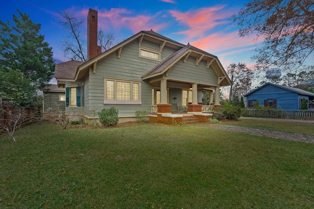 view of front facade featuring a lawn and a porch