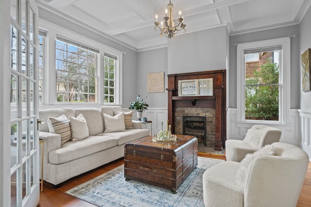 living room featuring beamed ceiling, crown molding, coffered ceiling, and hardwood / wood-style floors