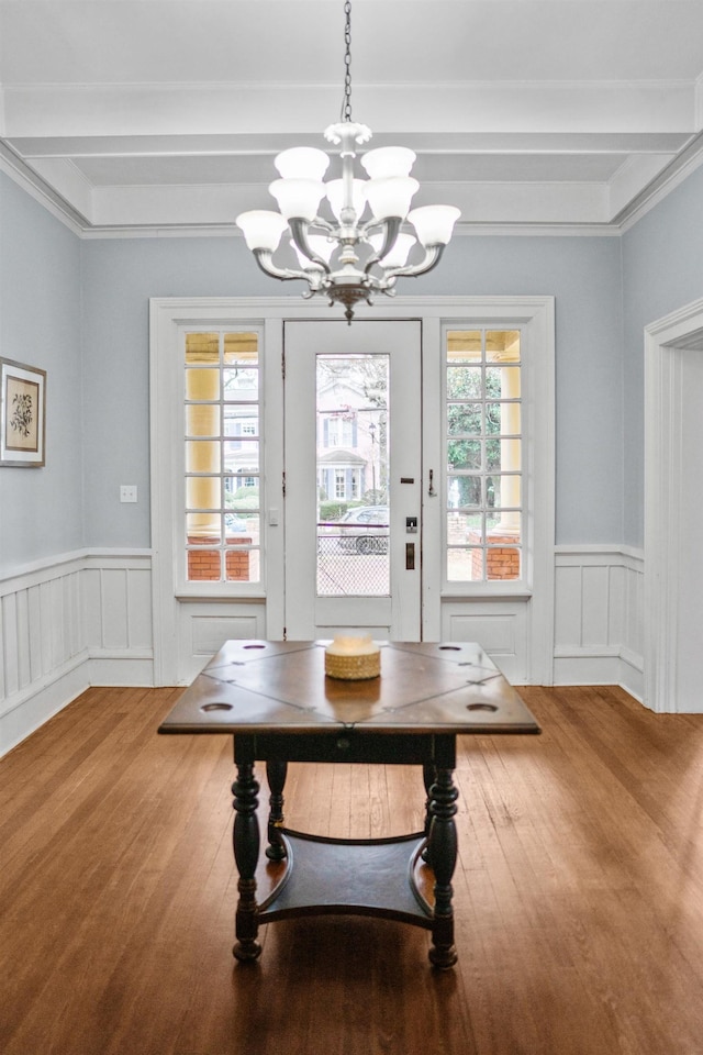 interior space featuring an inviting chandelier, wood-type flooring, and beamed ceiling