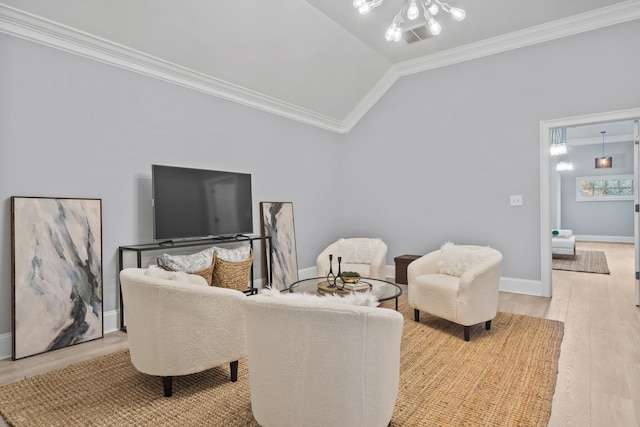 living room with crown molding, vaulted ceiling, and light wood-type flooring