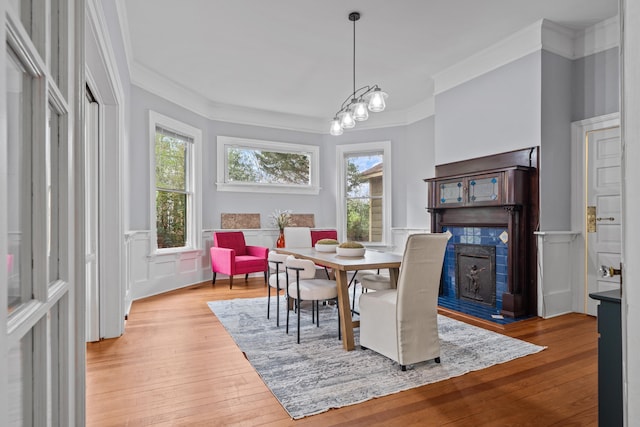 dining room with ornamental molding and light hardwood / wood-style floors