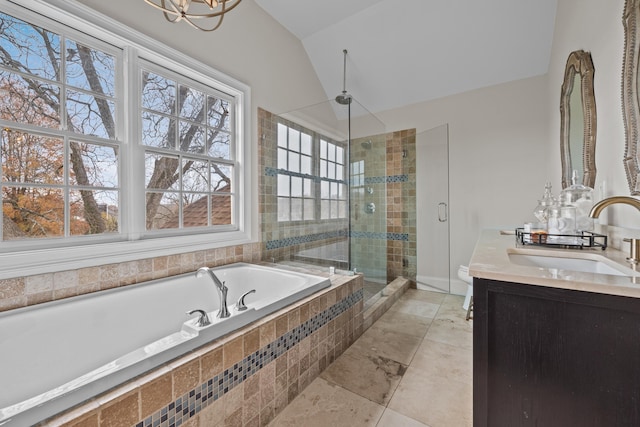 bathroom with vanity, shower with separate bathtub, and vaulted ceiling