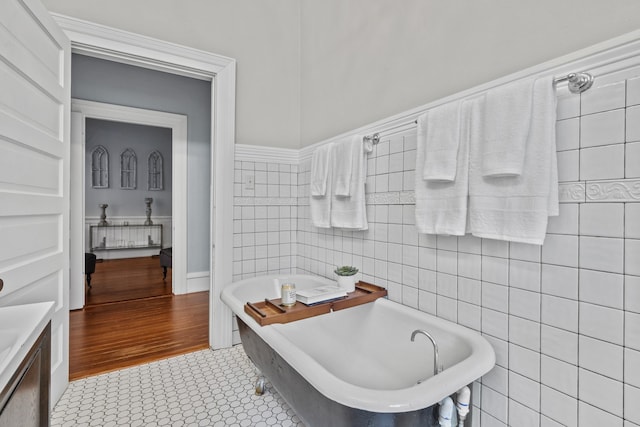 bathroom featuring a tub and tile walls