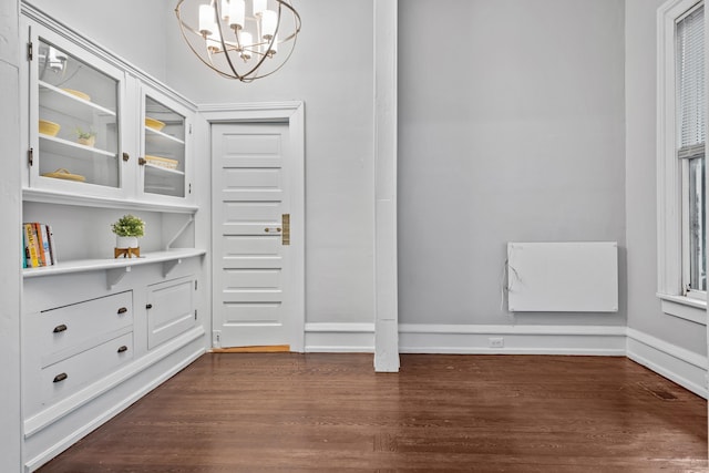 interior space featuring an inviting chandelier and dark hardwood / wood-style floors