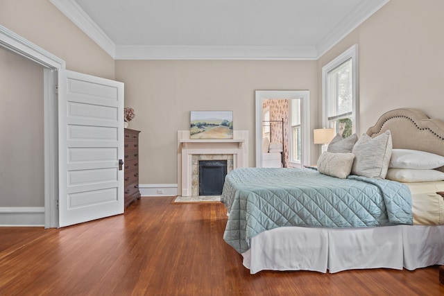 bedroom with hardwood / wood-style flooring and crown molding