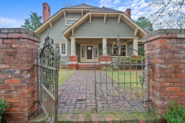 back of property featuring covered porch