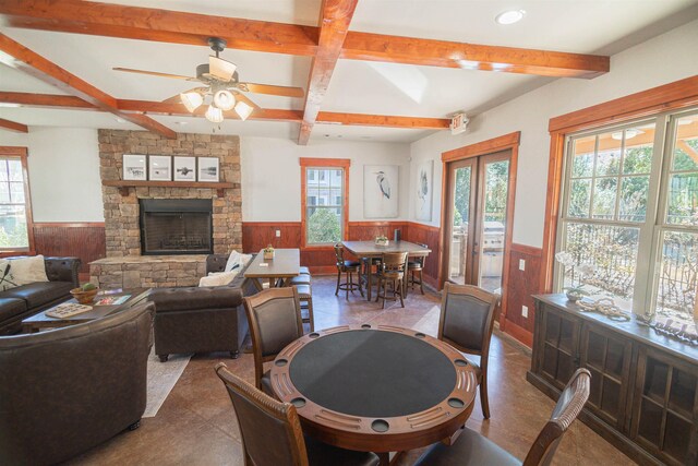 living room with ceiling fan, beam ceiling, coffered ceiling, a fireplace, and french doors