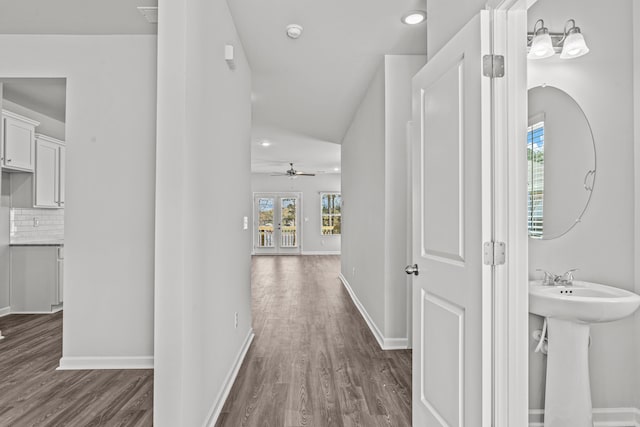 hallway featuring dark wood-type flooring and sink