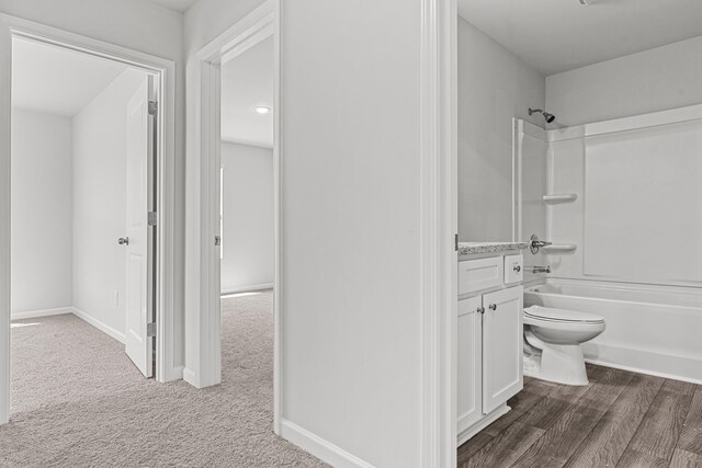 full bathroom with vanity, hardwood / wood-style floors, shower / bathtub combination, and toilet