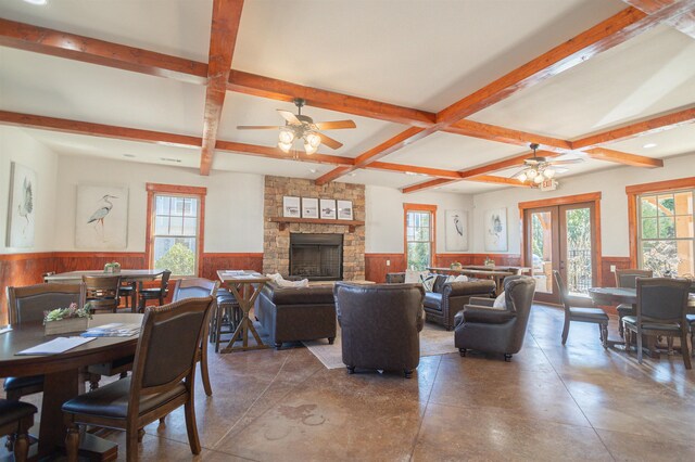 living room with beamed ceiling, plenty of natural light, and french doors