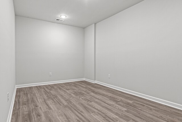 spare room with hardwood / wood-style floors