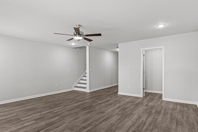 basement featuring ceiling fan and dark hardwood / wood-style floors