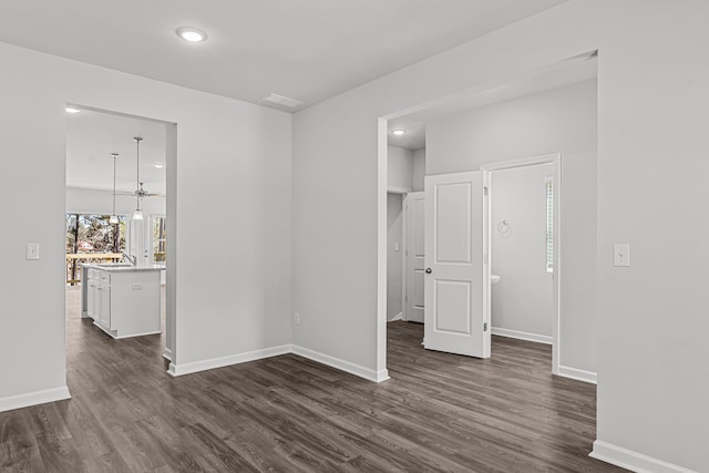 unfurnished room with dark wood-type flooring and sink