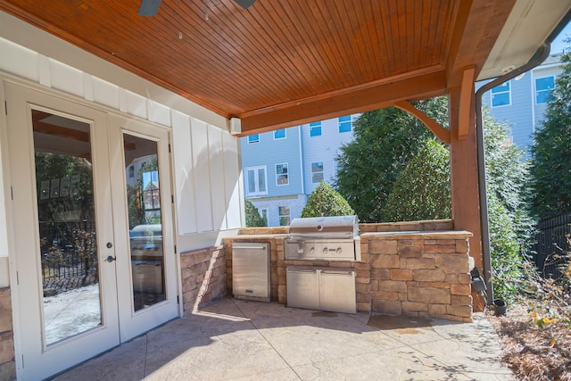 view of patio with exterior kitchen, ceiling fan, grilling area, and french doors