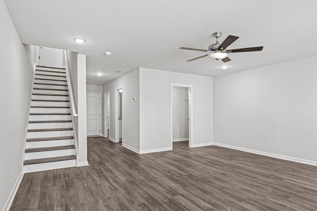 unfurnished living room featuring dark hardwood / wood-style floors and ceiling fan