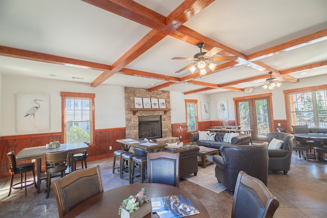 living room with coffered ceiling, a fireplace, french doors, and beamed ceiling