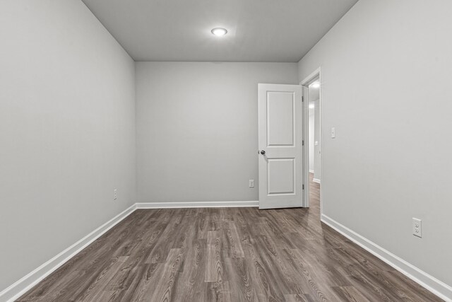 spare room with dark hardwood / wood-style flooring