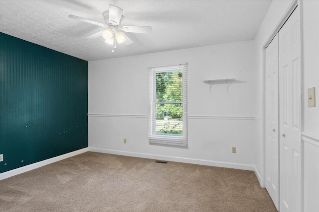 1120 Rawlings Dr, Rutledge, GA 30663 - unfurnished bedroom with carpet, a textured ceiling, a closet, and a ceiling fan