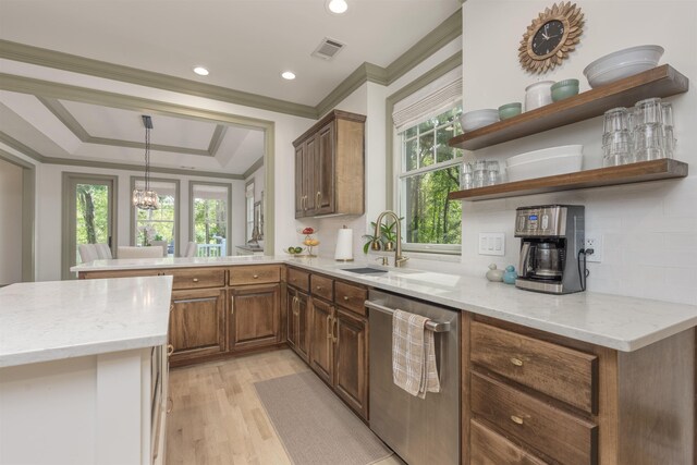 kitchen with dishwasher, pendant lighting, light stone counters, and kitchen peninsula