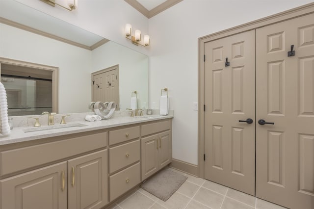 bathroom with crown molding, tile patterned floors, and vanity