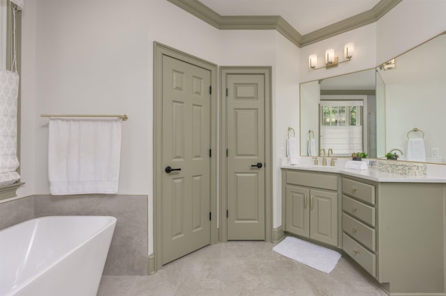 bathroom featuring vanity, crown molding, and a tub