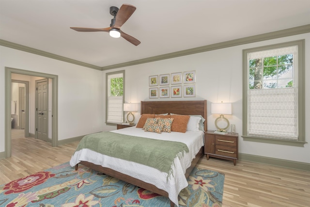 bedroom with crown molding, ceiling fan, and light hardwood / wood-style flooring