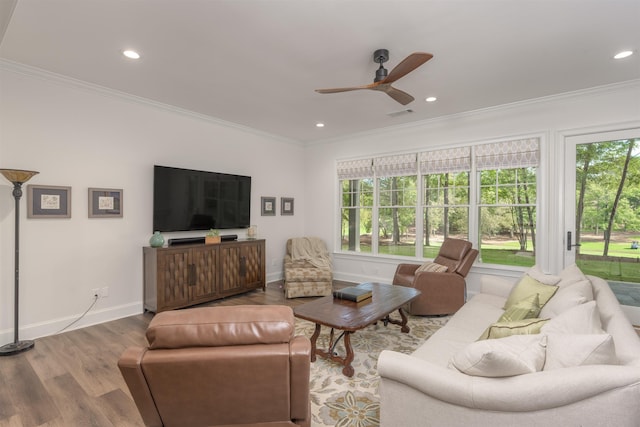 living room with crown molding, ceiling fan, and hardwood / wood-style flooring